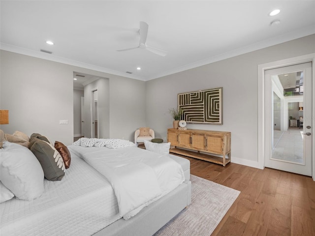 bedroom featuring ornamental molding, ceiling fan, and light hardwood / wood-style floors