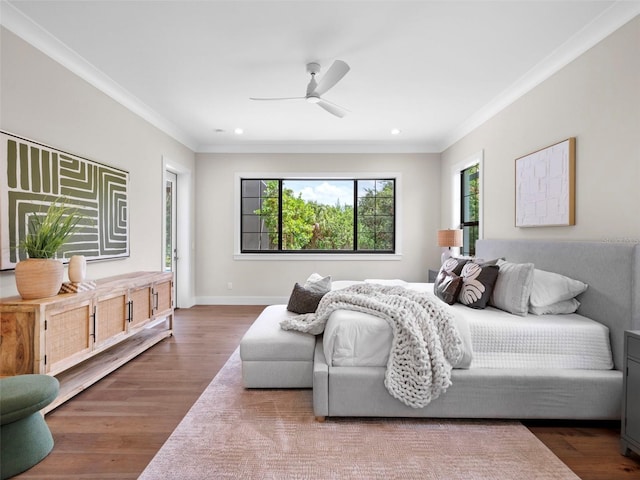 bedroom with crown molding, ceiling fan, and wood-type flooring