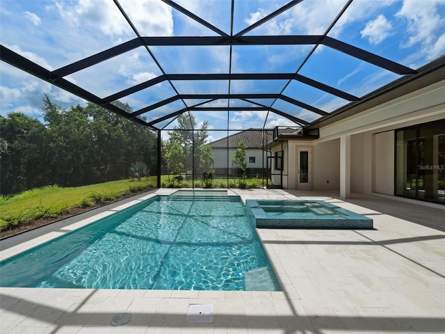 view of pool featuring an in ground hot tub, glass enclosure, and a patio