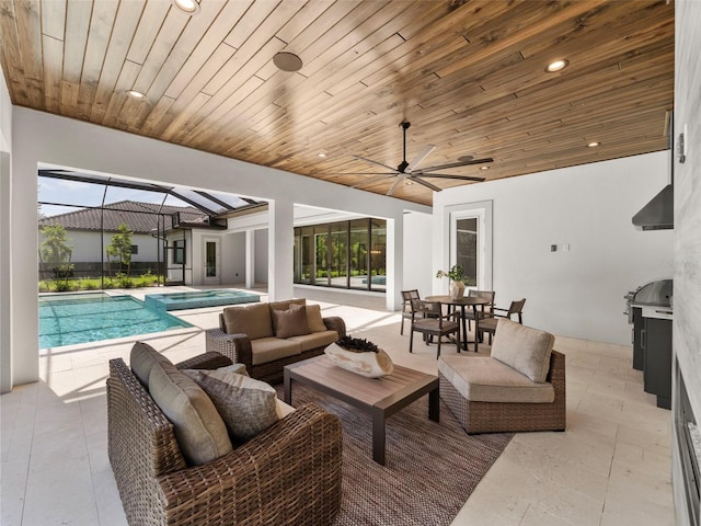 interior space featuring an outdoor living space, ceiling fan, and glass enclosure