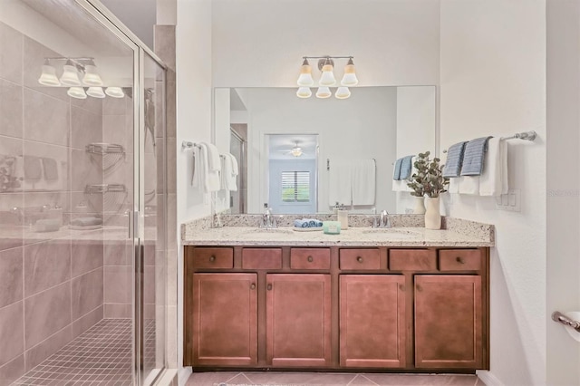 bathroom featuring tile patterned flooring, vanity, and an enclosed shower