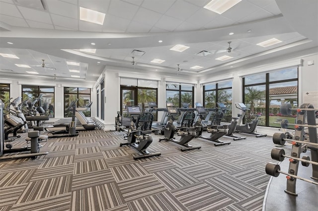 exercise room featuring carpet, ceiling fan, and a wealth of natural light