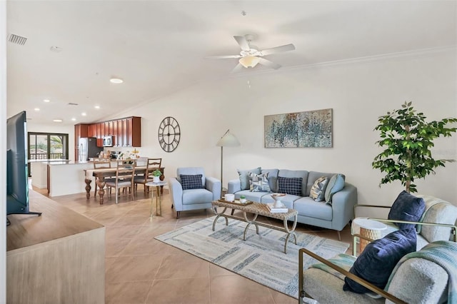 living room featuring ceiling fan, ornamental molding, light tile patterned floors, and lofted ceiling