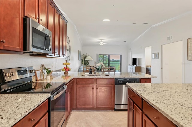 kitchen featuring appliances with stainless steel finishes, light stone counters, ceiling fan, and sink