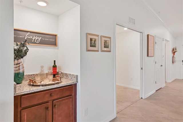 hallway featuring crown molding and light colored carpet