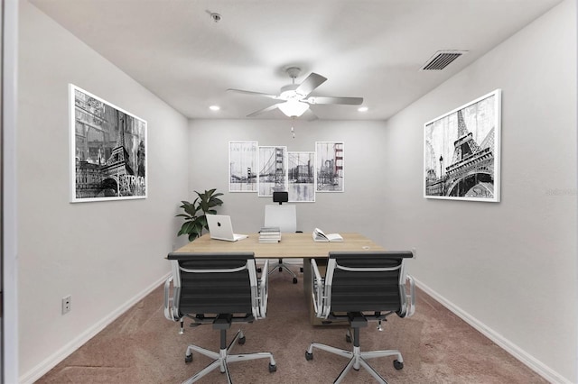 carpeted office space with ceiling fan