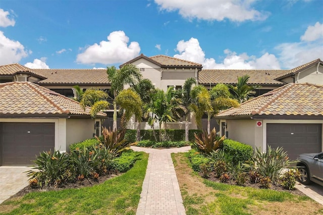 mediterranean / spanish-style house with a garage