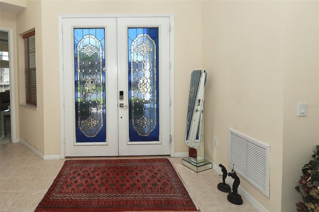 255 Royal Palm Dr, Davenport, FL 33837 - foyer with light tile patterned floors, french doors, visible vents, and baseboards