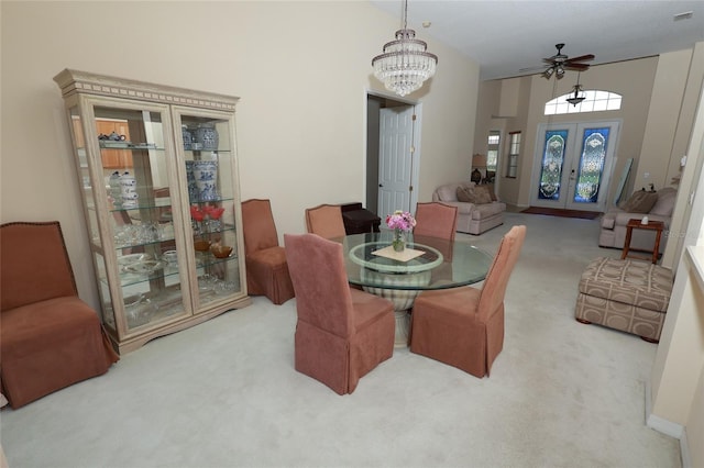 255 Royal Palm Dr, Davenport, FL 33837 - dining area with ceiling fan with notable chandelier, visible vents, a towering ceiling, french doors, and carpet