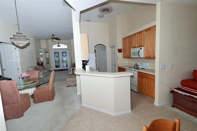 255 Royal Palm Dr, Davenport, FL 33837 - kitchen featuring white appliances, open floor plan, a peninsula, light countertops, and french doors