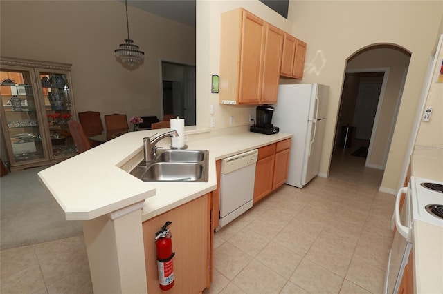 255 Royal Palm Dr, Davenport, FL 33837 - kitchen featuring white appliances, light countertops, a sink, and a peninsula