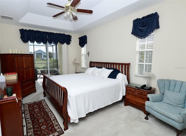 255 Royal Palm Dr, Davenport, FL 33837 - bedroom with visible vents, a raised ceiling, light colored carpet, ceiling fan, and access to exterior