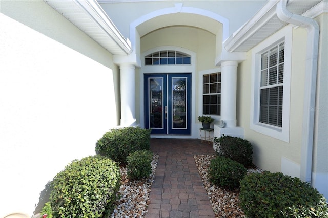 property entrance featuring french doors and stucco siding