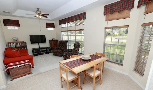 255 Royal Palm Dr, Davenport, FL 33837 - dining area with light carpet, baseboards, visible vents, a ceiling fan, and a tray ceiling