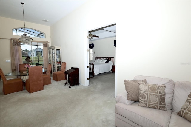 255 Royal Palm Dr, Davenport, FL 33837 - living room featuring light carpet and ceiling fan with notable chandelier