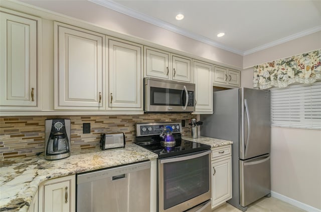 kitchen with ornamental molding, appliances with stainless steel finishes, light stone countertops, tasteful backsplash, and cream cabinets