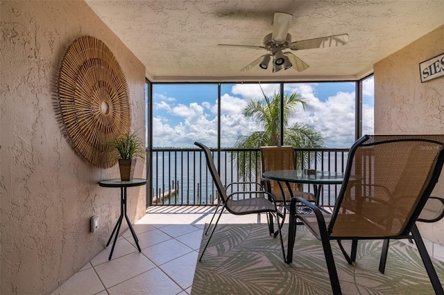 unfurnished sunroom featuring a healthy amount of sunlight and ceiling fan