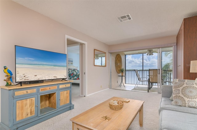 living room featuring light carpet and ceiling fan