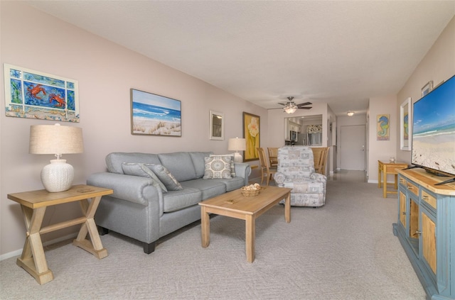 living room with light colored carpet and ceiling fan