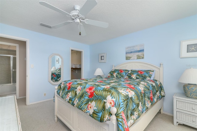 bedroom with a walk in closet, a textured ceiling, light colored carpet, and ceiling fan