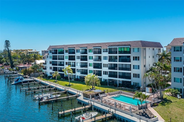 exterior space with a water view and a community pool