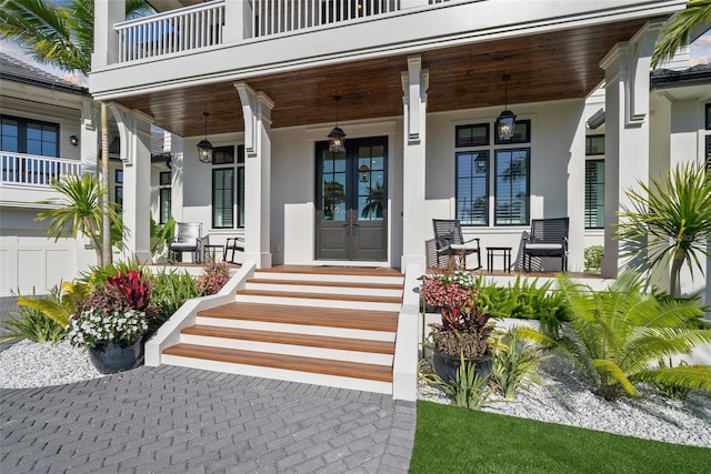 property entrance featuring a balcony and covered porch