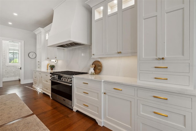 kitchen featuring white cabinetry, light stone countertops, dark hardwood / wood-style flooring, stainless steel stove, and custom exhaust hood