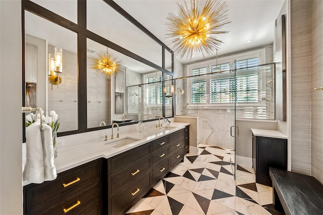 bathroom featuring vanity, an inviting chandelier, and an enclosed shower