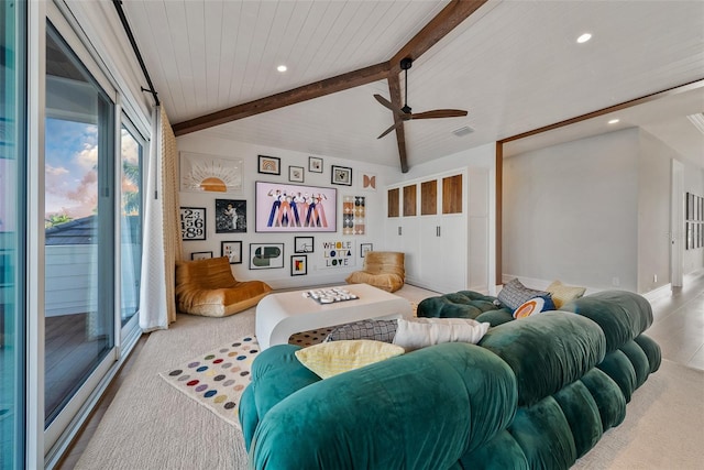 carpeted living room with vaulted ceiling with beams and ceiling fan