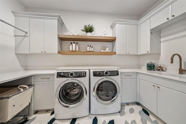 washroom featuring cabinets, separate washer and dryer, and sink