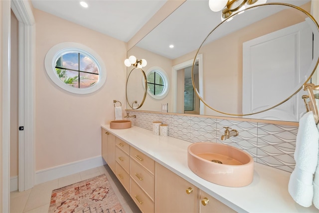 bathroom with backsplash, tile patterned flooring, and vanity