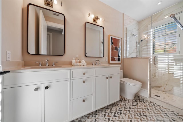 bathroom with tile patterned floors, vanity, toilet, and a shower with door