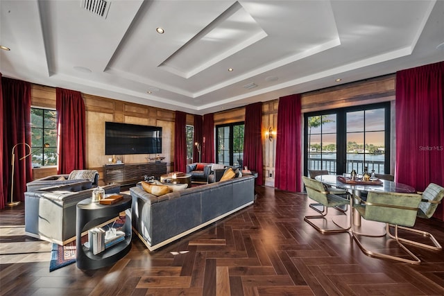 living room with plenty of natural light, french doors, and a tray ceiling