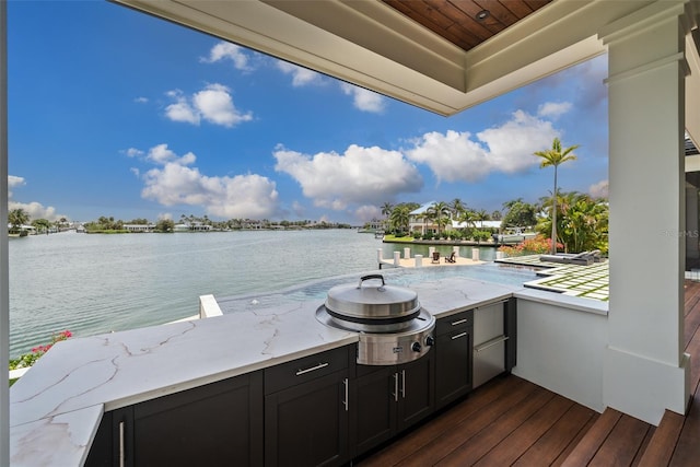 view of patio / terrace with a water view and an outdoor kitchen