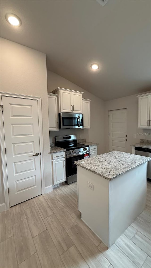 kitchen featuring a center island, stainless steel appliances, and white cabinetry