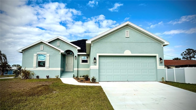 view of front of house featuring a front yard and a garage