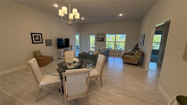 dining area featuring light wood-type flooring, an inviting chandelier, baseboards, and recessed lighting