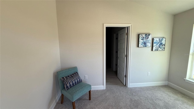 interior space featuring carpet flooring and baseboards