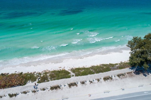 drone / aerial view featuring a water view and a view of the beach