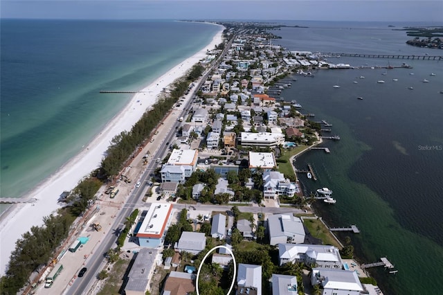 drone / aerial view with a water view and a beach view