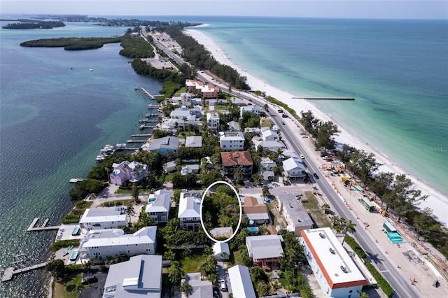 birds eye view of property with a water view and a view of the beach