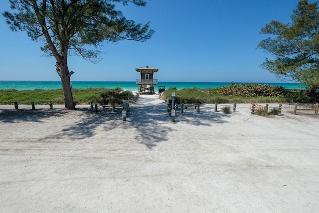 view of property's community with a view of the beach and a water view
