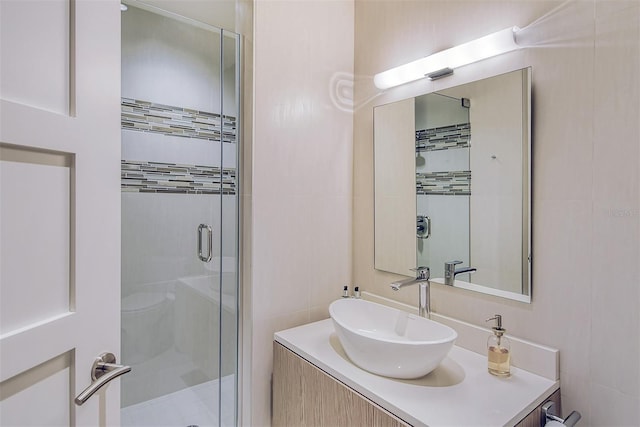 bathroom featuring vanity and a shower with door