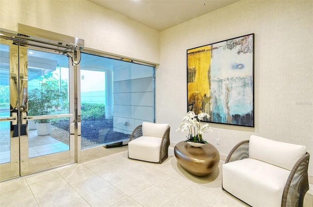 living area featuring french doors and tile patterned flooring