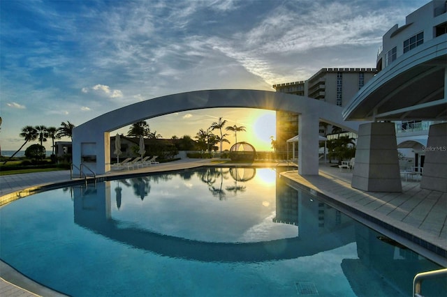 pool at dusk with a patio