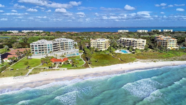 aerial view with a water view and a beach view