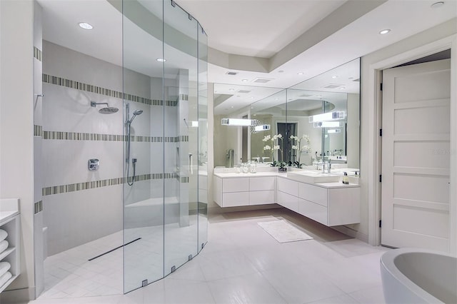 bathroom featuring tile patterned flooring, vanity, and plus walk in shower