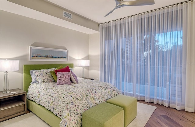 bedroom with ceiling fan and hardwood / wood-style flooring