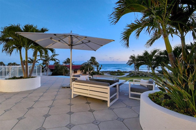 view of patio with a water view and outdoor lounge area