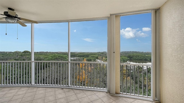 unfurnished sunroom with ceiling fan and a wealth of natural light